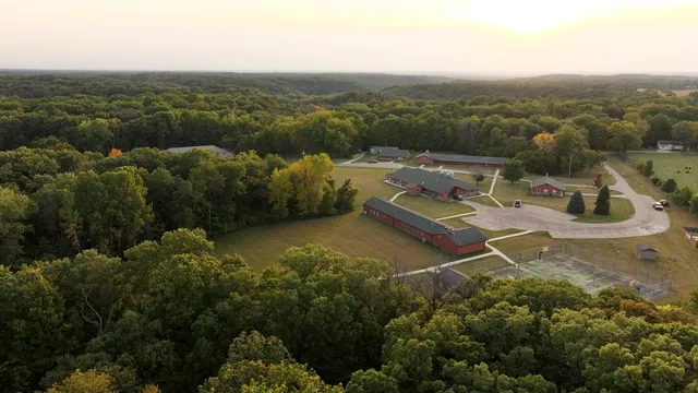 an aerial view of field and trees