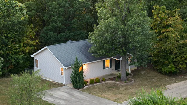 an aerial view of a house with swimming pool and outdoor space