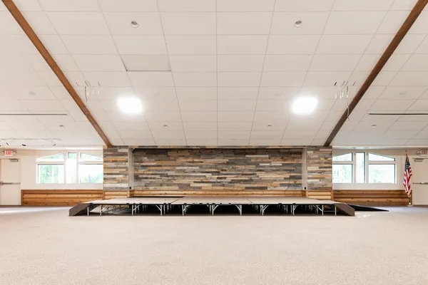 a kitchen with a sink stove and wooden floor