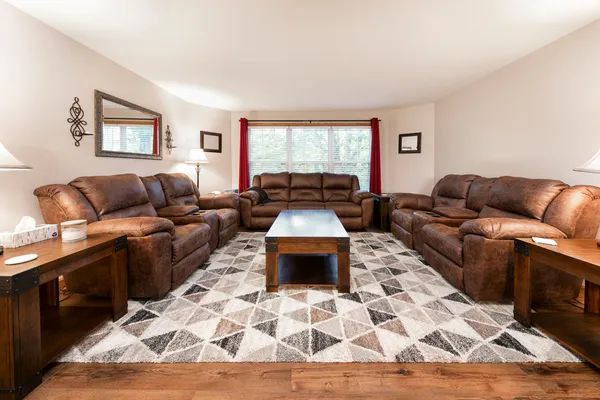 a living room with lots of furniture and wooden floor