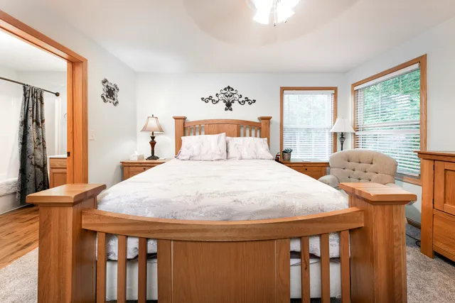 a bathroom with a granite countertop sink a mirror and shower