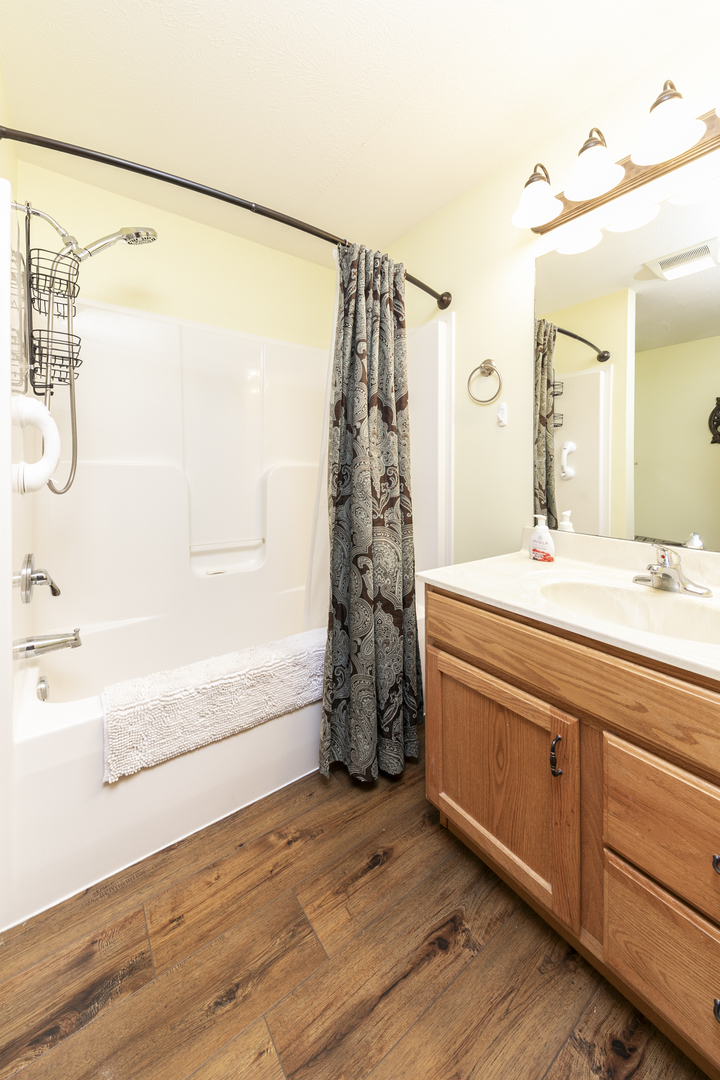 823 Columbia Road Washburn, IL 61570 - Photo 34 of 46 a bathroom with a granite countertop sink a mirror and shower