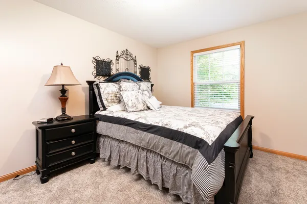 a bedroom with two beds and painting on the wall