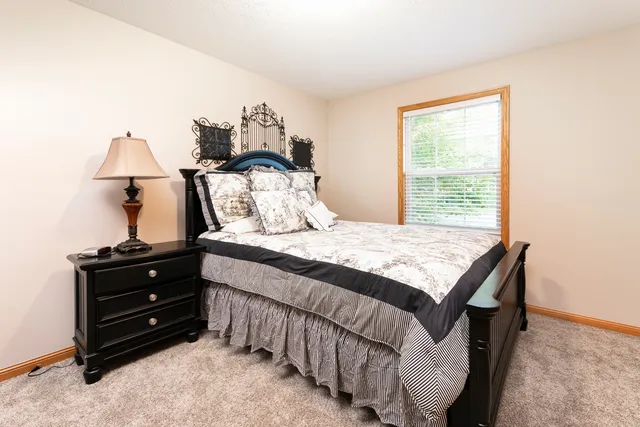 a bedroom with two beds and painting on the wall