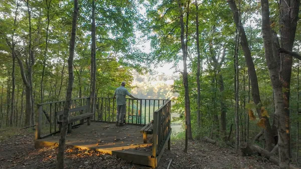 a view of a chair and fire pit in the middle of a yard