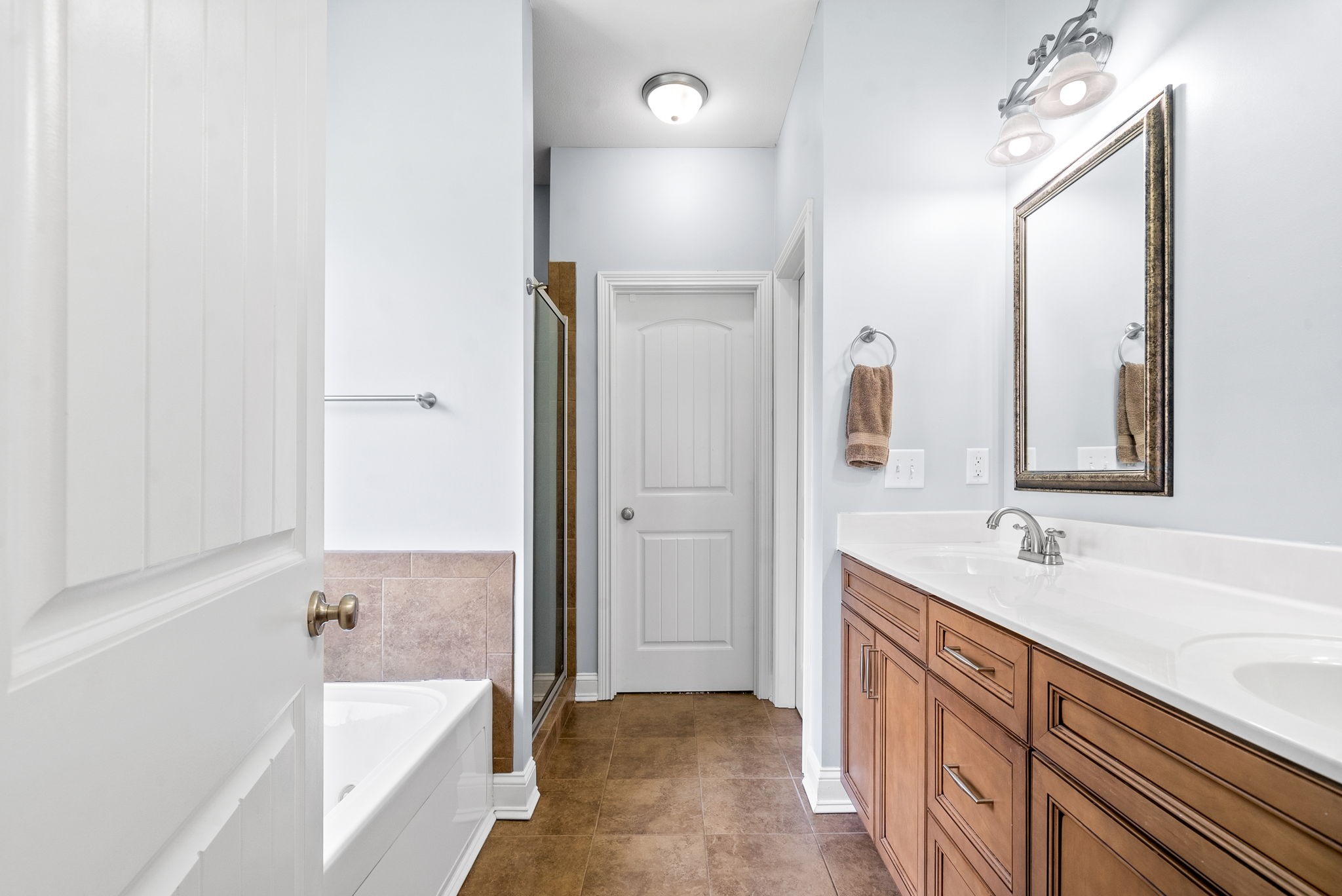 4244 Sango Road Clarksville, TN 37043 - Photo 23 of 43 a bathroom with a tub sink and mirror