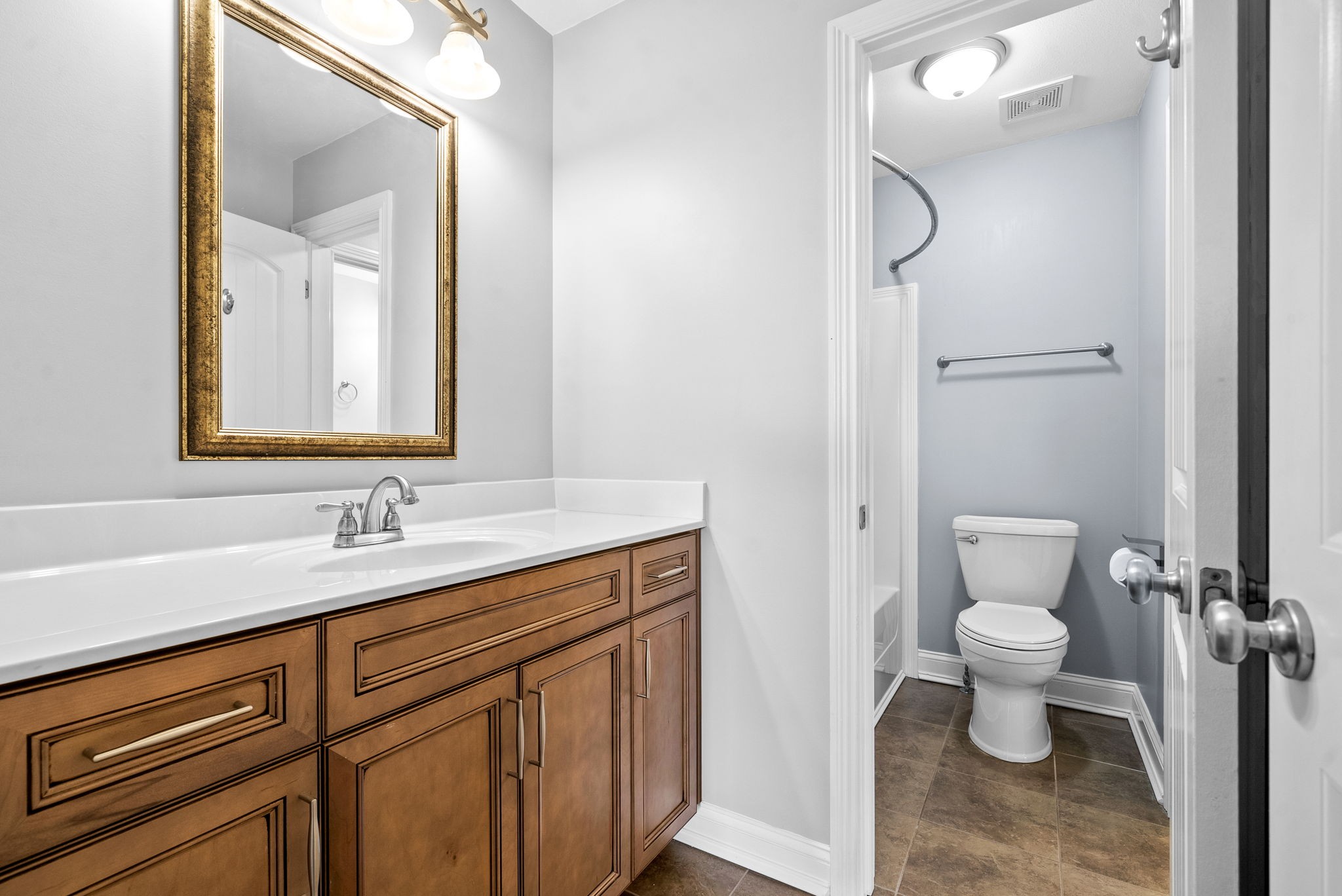 4244 Sango Road Clarksville, TN 37043 - Photo 32 of 43 a bathroom with a toilet sink and mirror