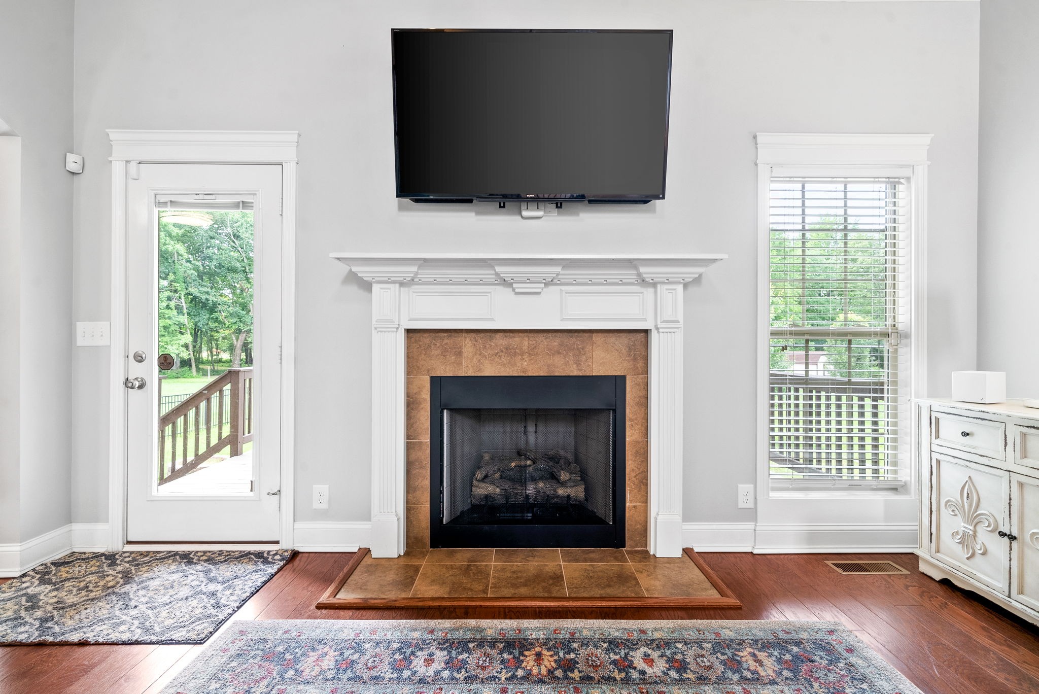 4244 Sango Road Clarksville, TN 37043 - Photo 6 of 43 a living room with a fireplace and a flat screen tv