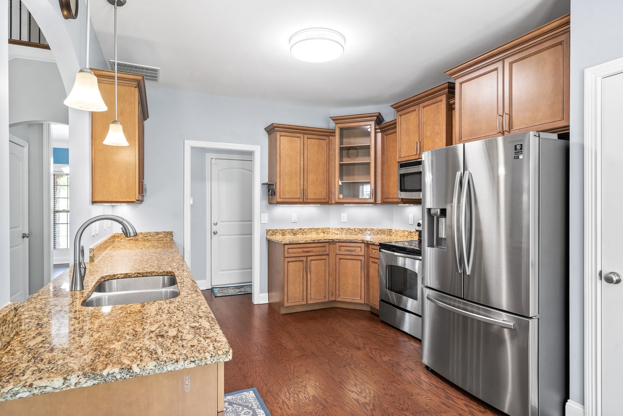 4244 Sango Road Clarksville, TN 37043 - Photo 10 of 43 a kitchen with granite countertop stainless steel appliances a refrigerator stove top oven and sink