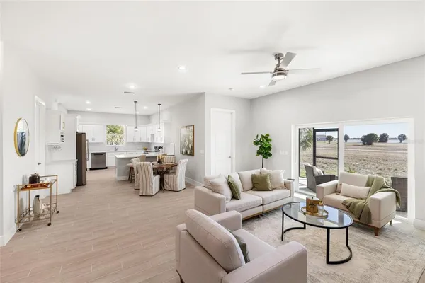 a living room with furniture and a floor to ceiling window