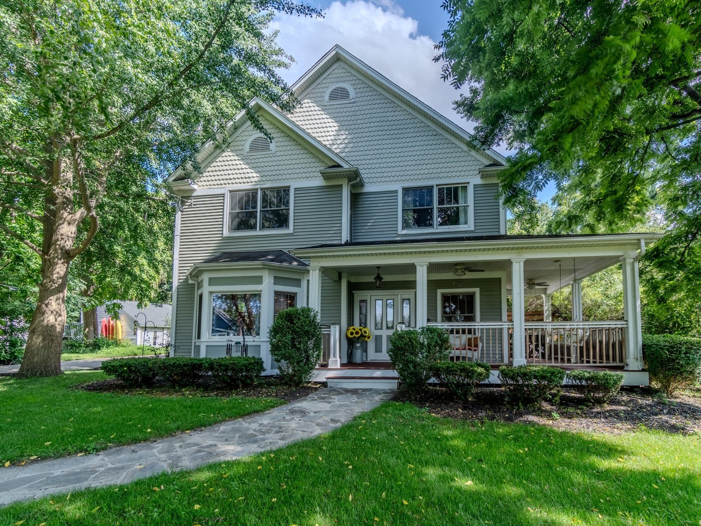 a front view of a house with a yard and porch