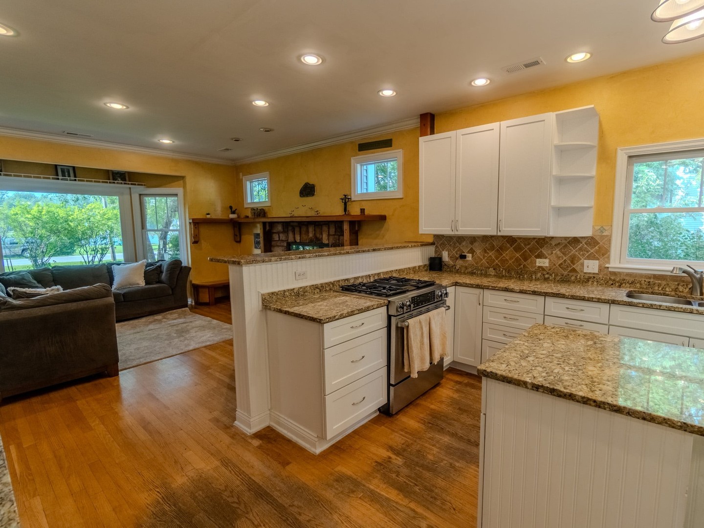 215 North River Road Fox River Grove, IL 60021 - Photo 11 of 25 a kitchen with stainless steel appliances granite countertop a stove a sink a refrigerator and a oven with wooden floor