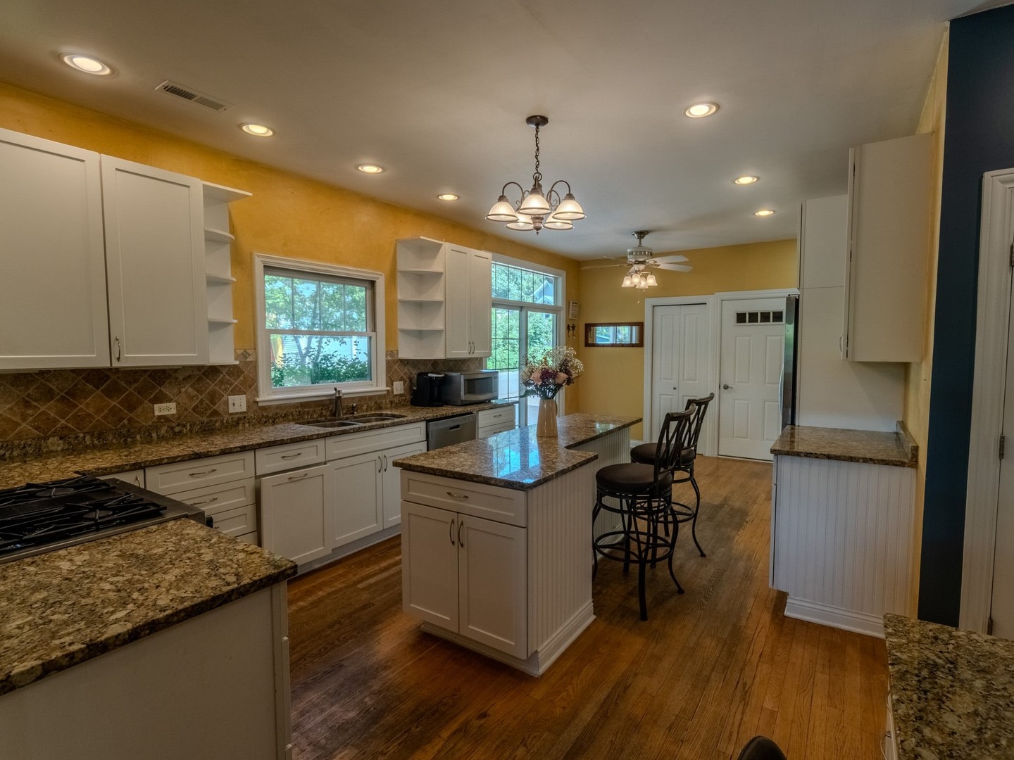 215 North River Road Fox River Grove, IL 60021 - Photo 12 of 25 a kitchen with stainless steel appliances granite countertop sink stove refrigerator and wooden floor