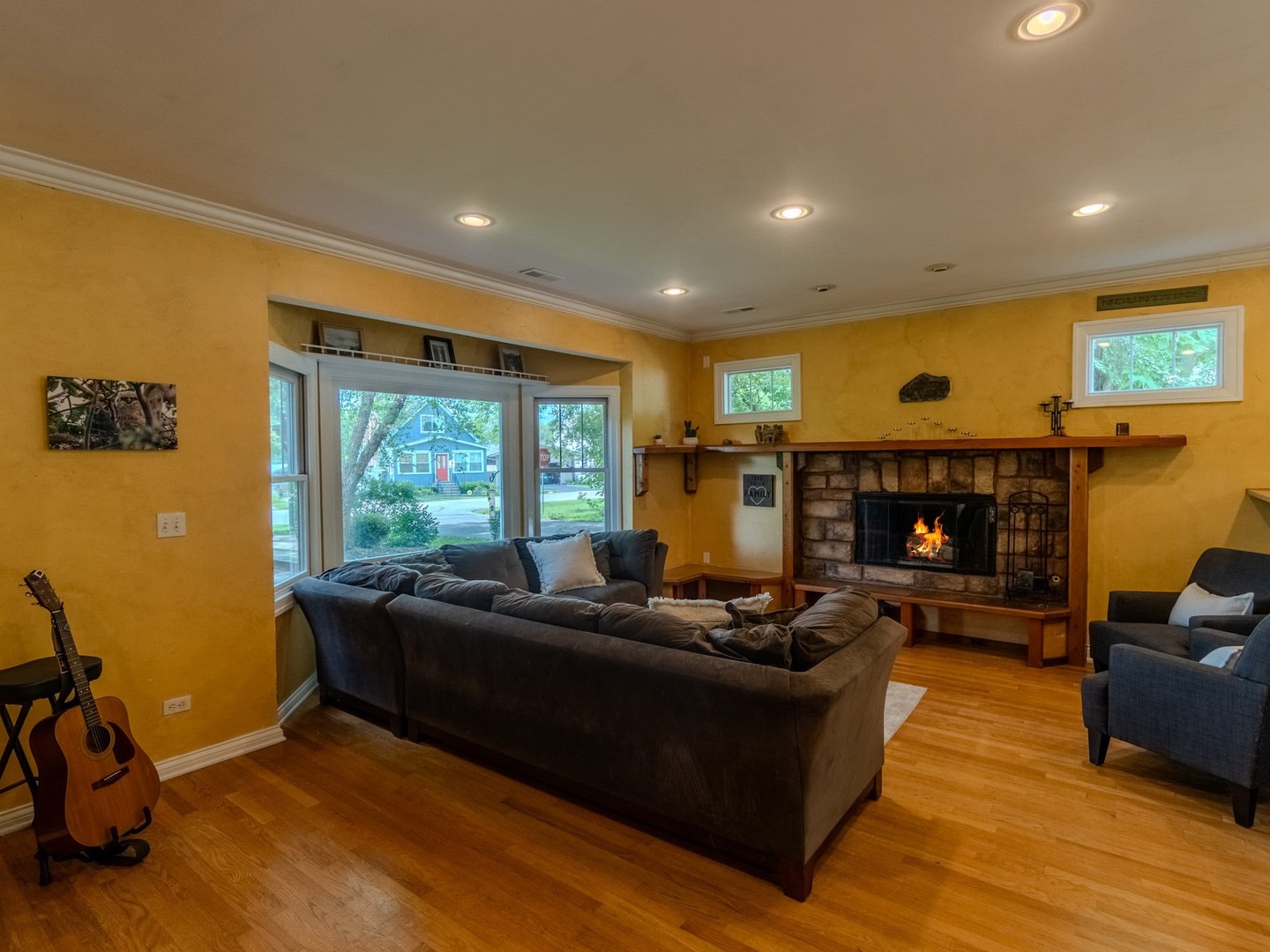 215 North River Road Fox River Grove, IL 60021 - Photo 9 of 25 a living room with furniture a fireplace and a flat screen tv