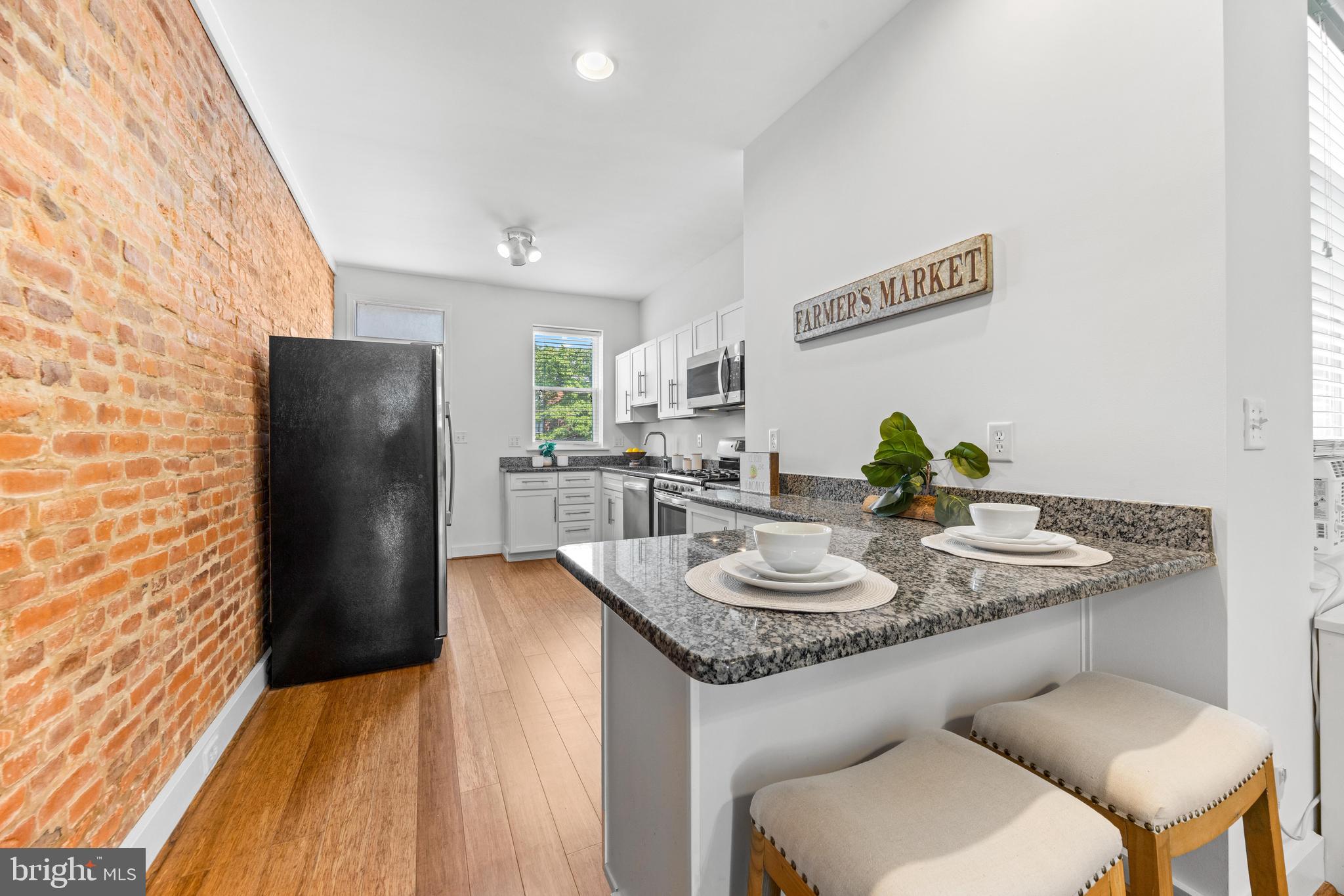 3353 Beech Avenue Baltimore, MD 21211 - Photo 12 of 32 a dining room with furniture and a refrigerator