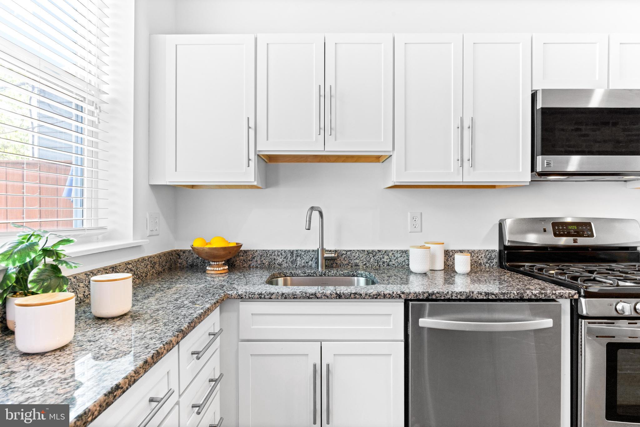 3353 Beech Avenue Baltimore, MD 21211 - Photo 14 of 32 a kitchen with granite countertop a stove a sink and a granite counter tops