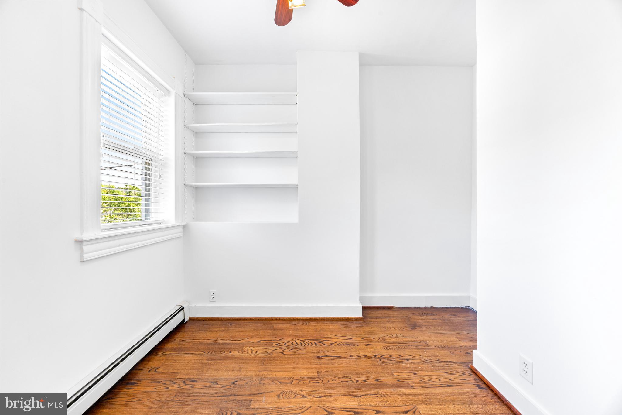3353 Beech Avenue Baltimore, MD 21211 - Photo 22 of 32 a view of a room with wooden floor and a window