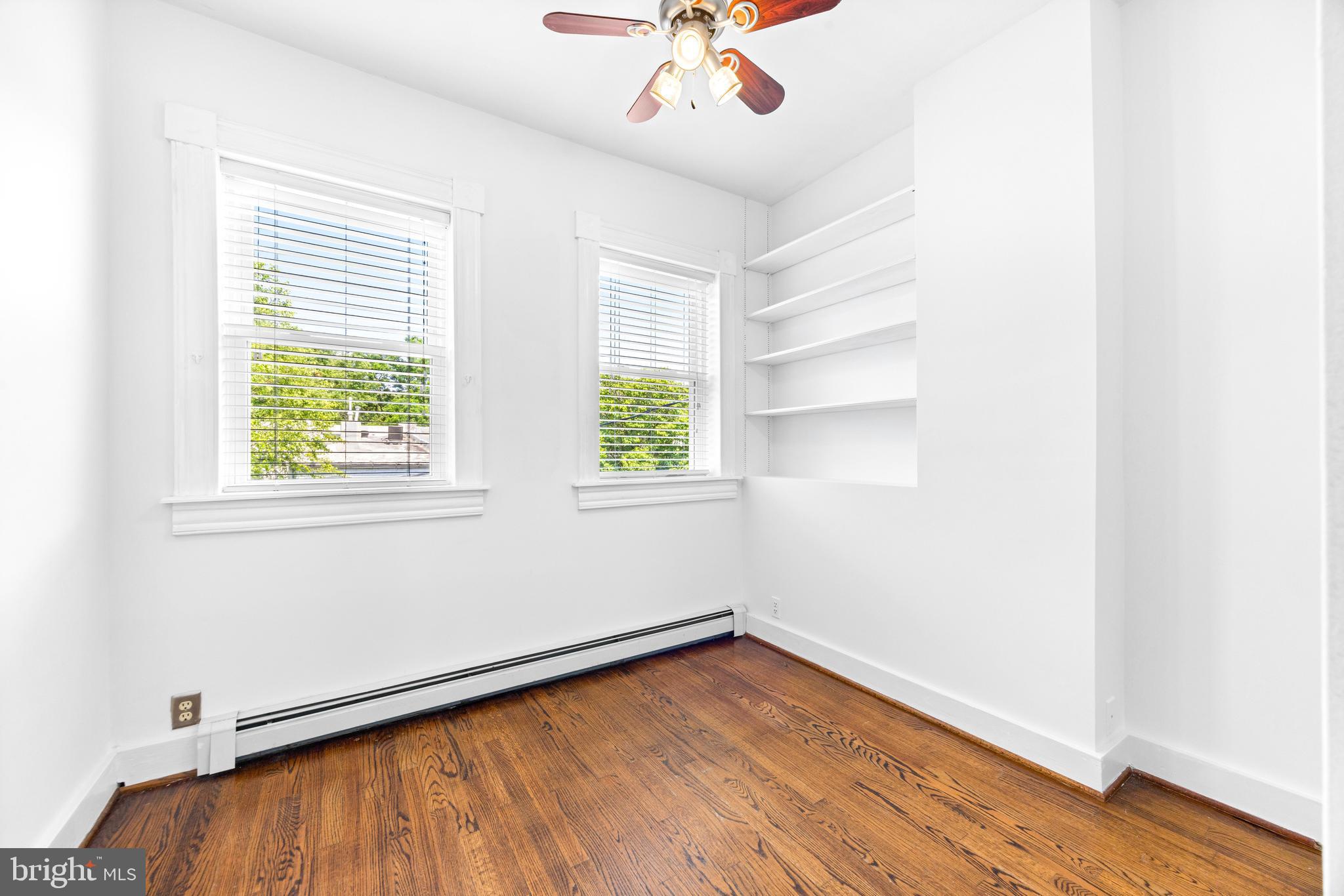 3353 Beech Avenue Baltimore, MD 21211 - Photo 23 of 32 an empty room with a window and wooden floor