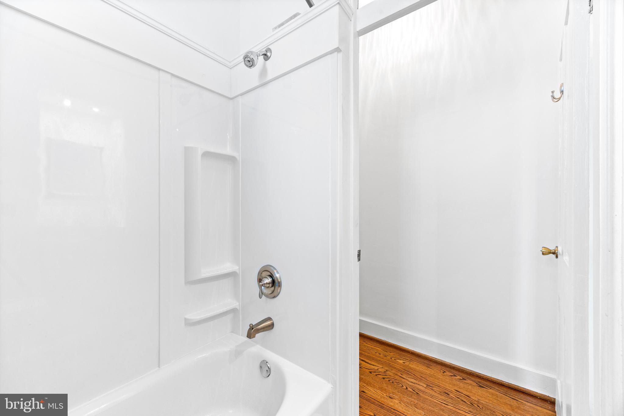 3353 Beech Avenue Baltimore, MD 21211 - Photo 28 of 32 a bathroom with a bathtub and shower