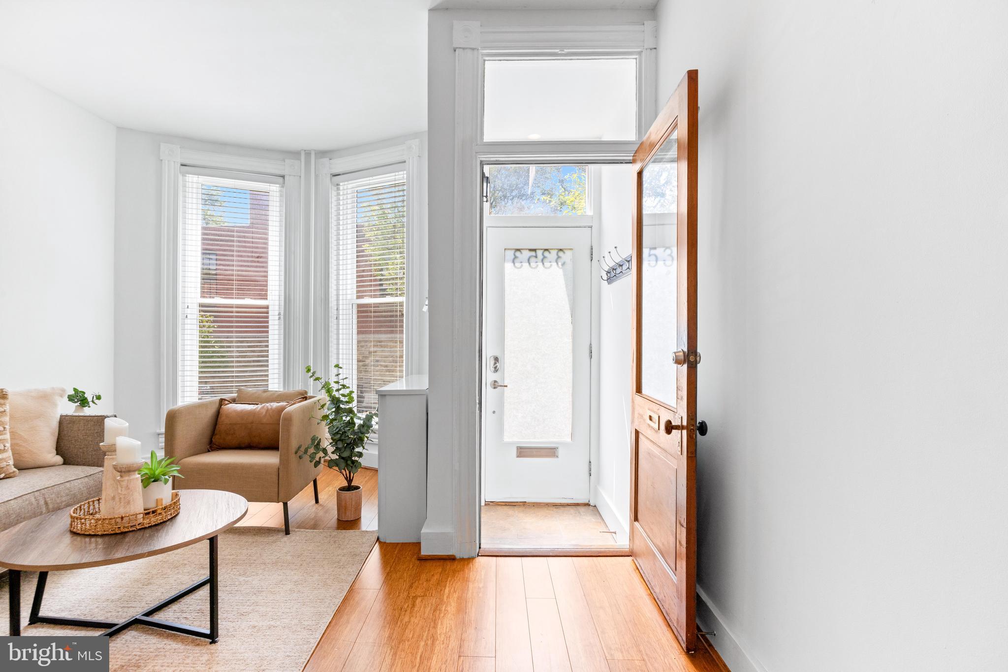 3353 Beech Avenue Baltimore, MD 21211 - Photo 3 of 32 a hallway with furniture and wooden floor