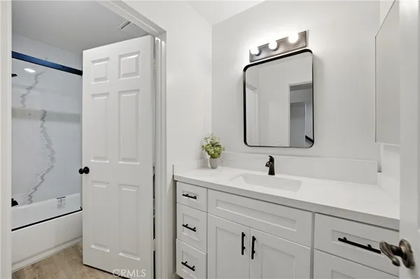 a bathroom with a double vanity sink mirror and shower