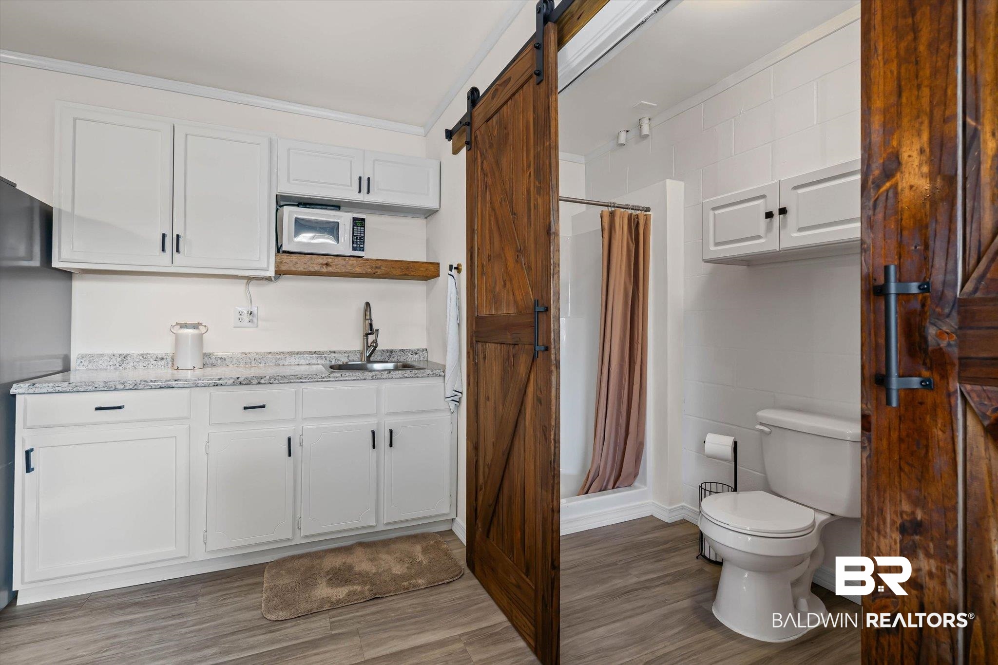 4567 Pine Avenue Saraland, AL 36571 - Photo 37 of 48 Full bath with a shower stall, light wood-type flooring, crown molding, and vanity
