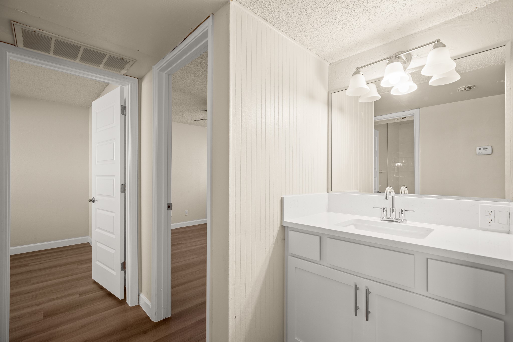 2408 Longview Street, Unit 112 Austin, TX 78705 - Photo 8 of 15 a bathroom with a sink vanity and a mirror