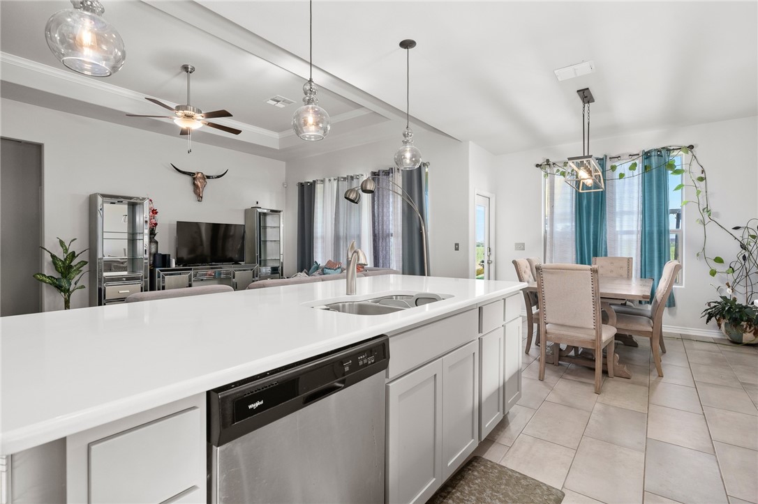 1031 Ocean Breeze Portland, TX 78374 - Photo 11 of 35 a kitchen with a sink a counter and chairs