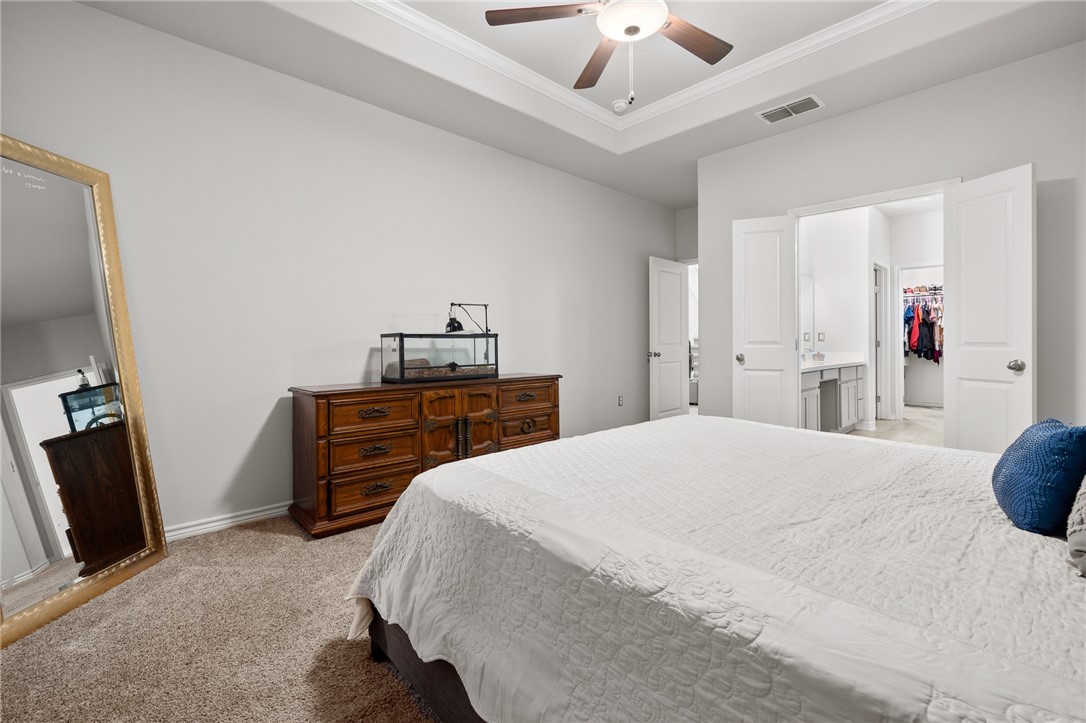 1031 Ocean Breeze Portland, TX 78374 - Photo 14 of 35 a bedroom with a bed and a flat tv screen on a dresser