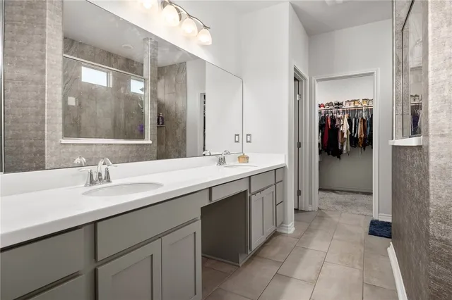 a bathroom with a double vanity sink and mirror