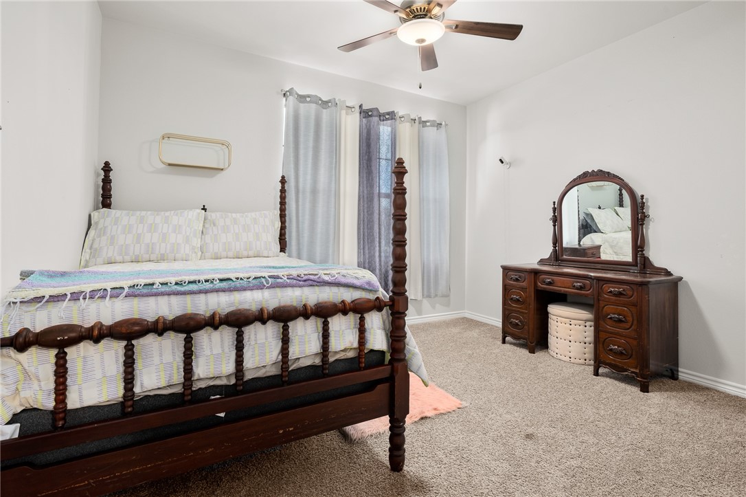 1031 Ocean Breeze Portland, TX 78374 - Photo 19 of 35 a bedroom with furniture and a chandelier