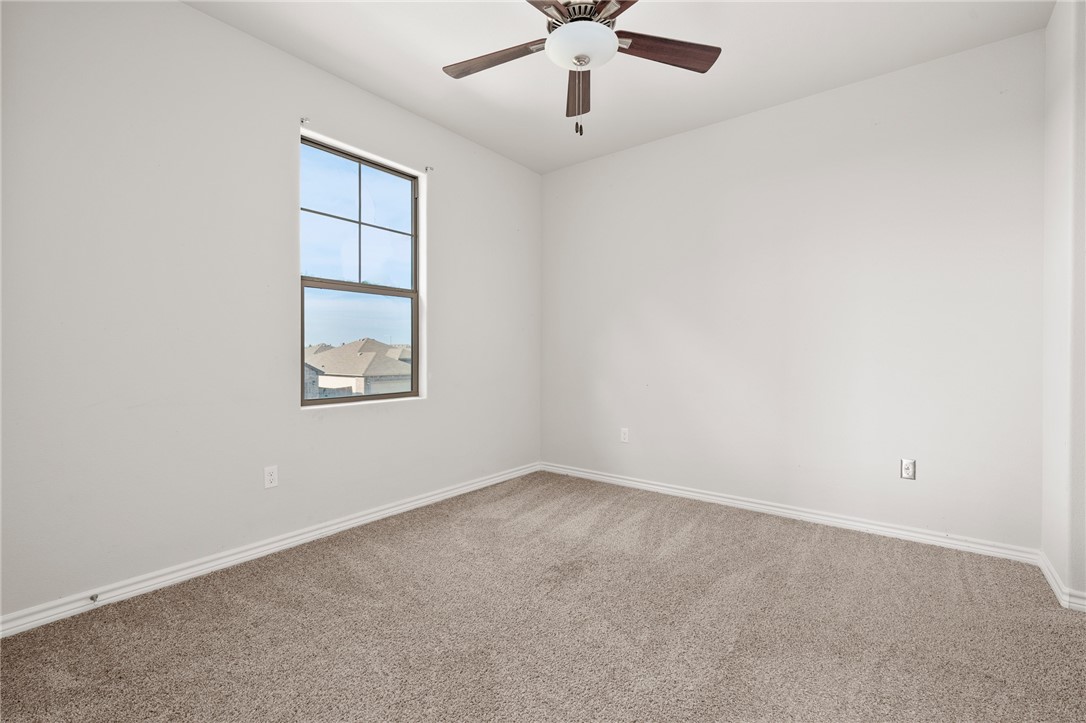 1031 Ocean Breeze Portland, TX 78374 - Photo 24 of 35 an empty room with a window and a fan