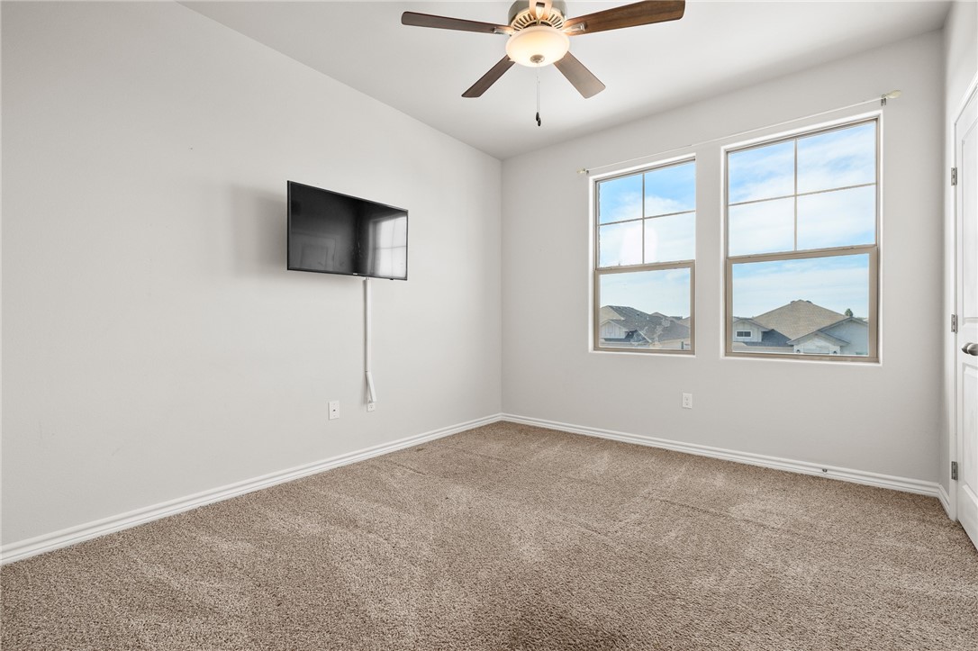 1031 Ocean Breeze Portland, TX 78374 - Photo 25 of 35 an empty room with windows and fan