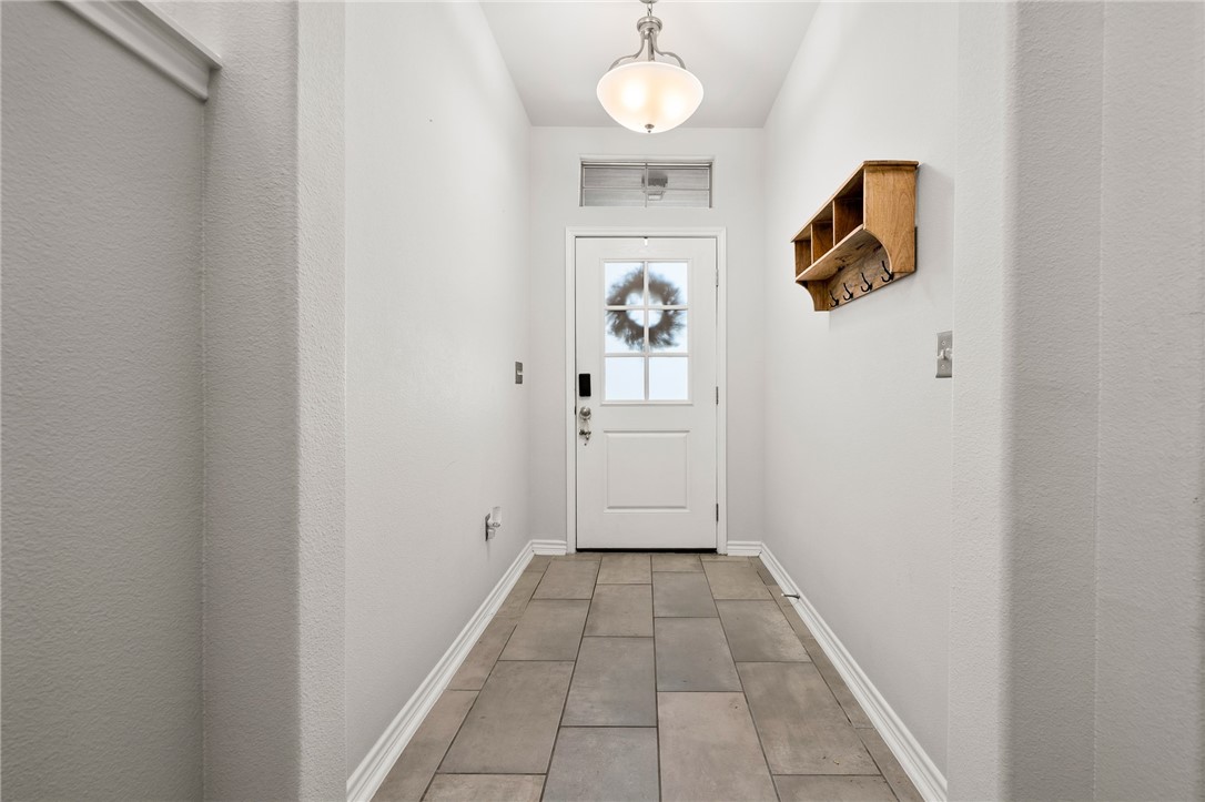 1031 Ocean Breeze Portland, TX 78374 - Photo 4 of 35 a view of a hallway with wooden floor and a bathroom