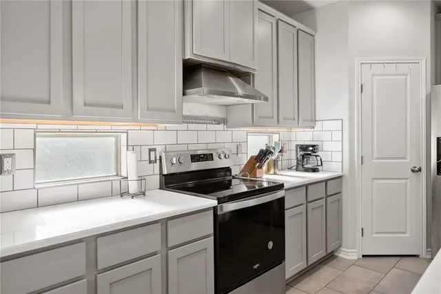 a kitchen with sink cabinets and appliances