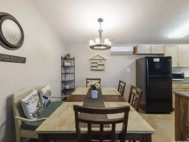 a dining room with furniture and wooden floor