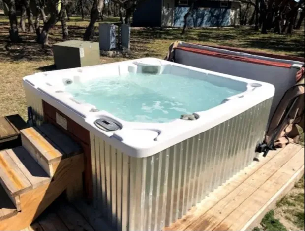 a view of a backyard with plants and patio