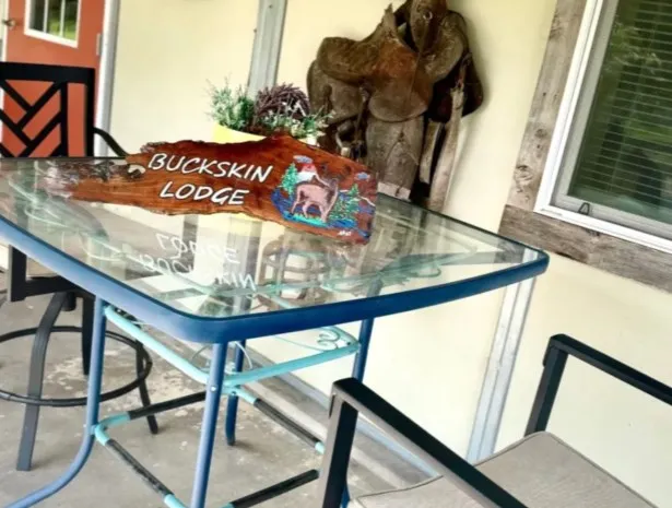 a living room with furniture a rug and a chandelier