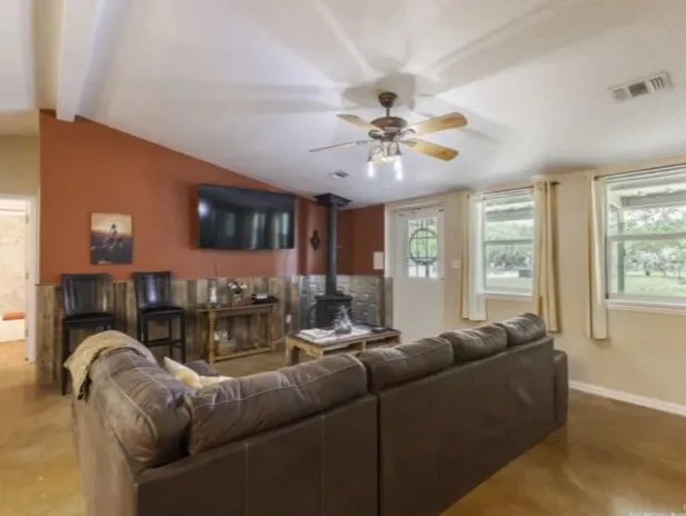 a kitchen with kitchen island granite countertop a sink stainless steel appliances and cabinets