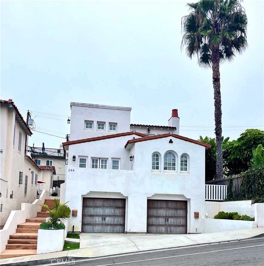 244 Avenida Granada, Unit B San Clemente, CA 92672 - Photo 1 of 19 a front view of a white building with palm trees