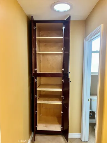 a view of walk in closet with empty racks