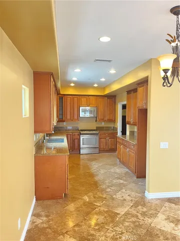 a view of a kitchen with kitchen island a counter top space cabinets and appliances
