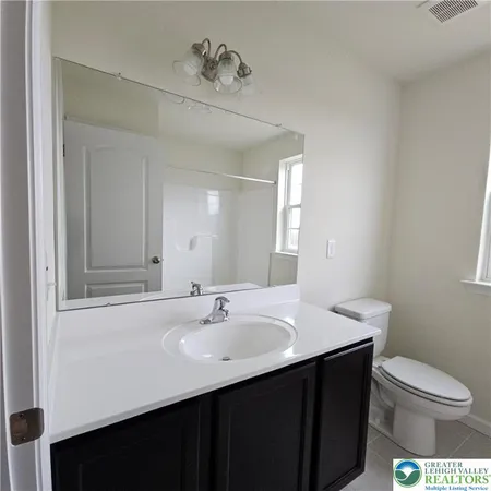 a bathroom with a sink a toilet and mirror