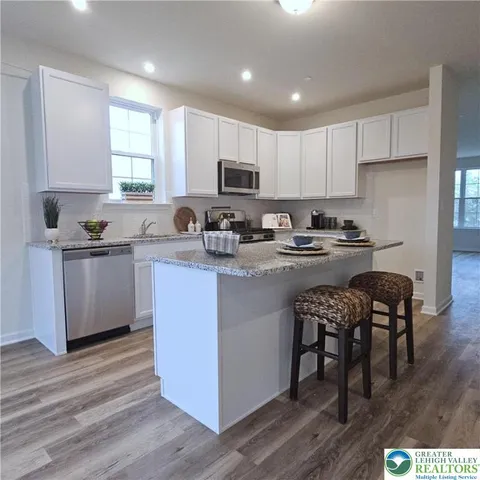a kitchen with a sink a stove a microwave and cabinets