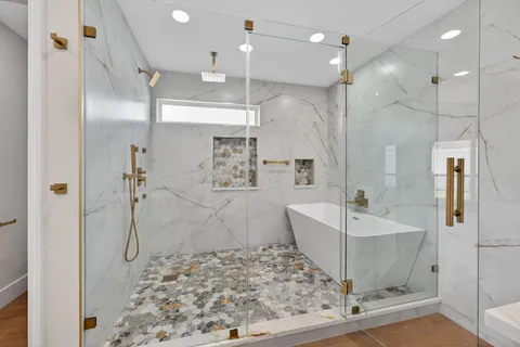 a bathroom with a bathtub and shower