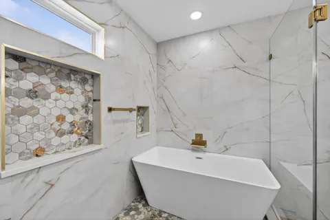 a bathroom with a bathtub and shower