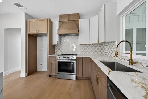 a kitchen with a sink and cabinets