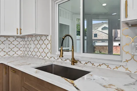 a stove top oven sitting inside of a kitchen