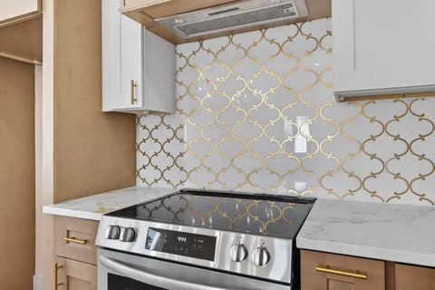 a kitchen with stainless steel appliances granite countertop a stove and a refrigerator