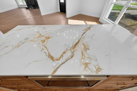 a kitchen with stainless steel appliances granite countertop a sink a stove and a refrigerator